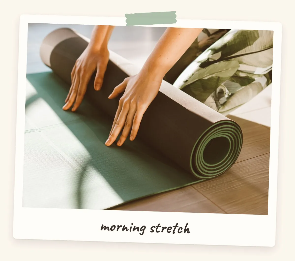 Hands rolling out a sage green yoga mat in morning sun for a health and fitness vision board