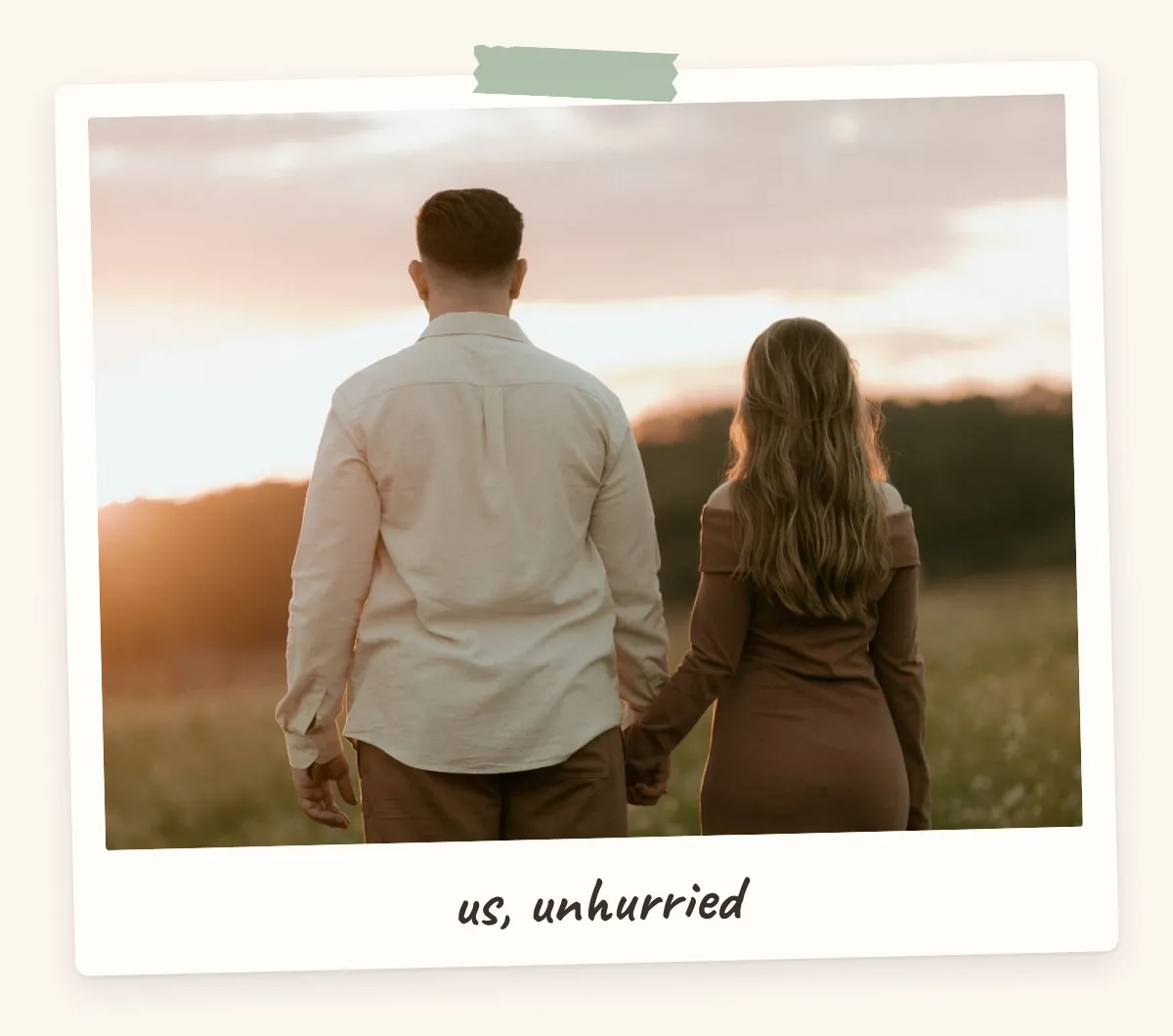 Couple holding hands in a meadow at sunset, seen from behind, for a love and relationships vision board