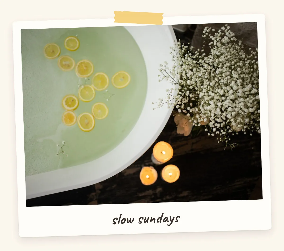 Bath with lemon slices, candles and baby's breath flowers for a self-care vision board